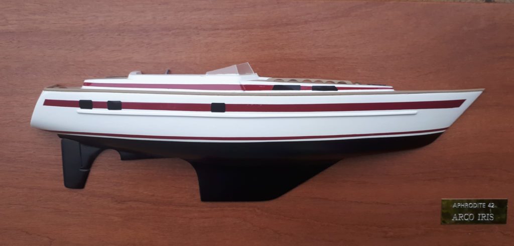 A half model of a ship mounted on a vertical wooden plate.
