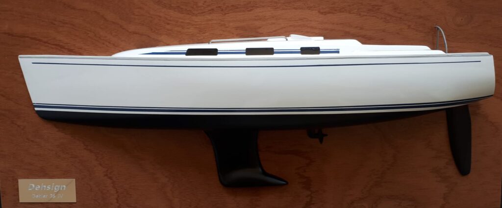 A half model of a ship mounted on a vertical wooden plate.