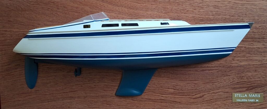 A half model of a ship mounted on a vertical wooden plate.