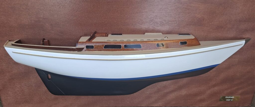 A half model of a ship mounted on a vertical wooden plate.